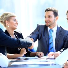 Two business colleagues shaking hands during meeting